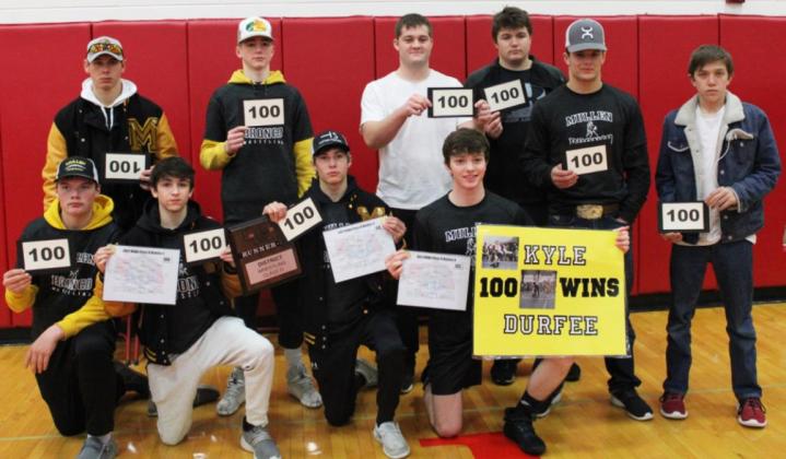 Kyle Durfee (holding his sign in the front row) celebrates his 100th win with his teammates, pictured back l-r: Sean Simonson, Chase Gracey, Tel Kvanvig, Isaac Welch, Spencer DeNaeyer, Carter Haesler. Front: Owen Thorberg, Jeffery Forsen, Eli Paxton and Kyle. Kris Forsen