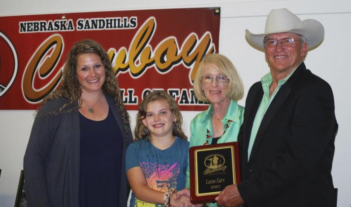 Accepting Leon Gift’s plaque from AB Cox is his daughter, Ginger, granddaughter Wesley and widow, Rose. courtesy photo